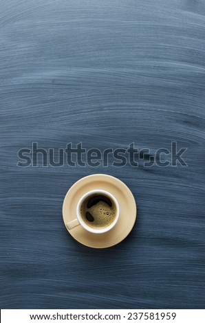 Single coffee cup over chalk textured table, above view