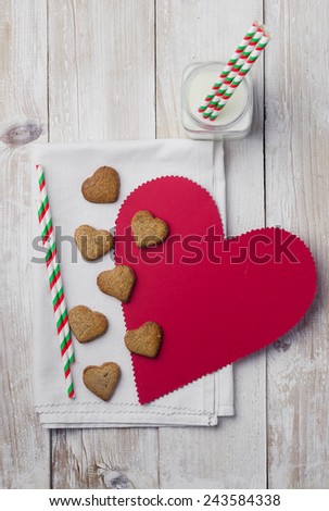 Homemade heart shaped cookies and red paper hearth