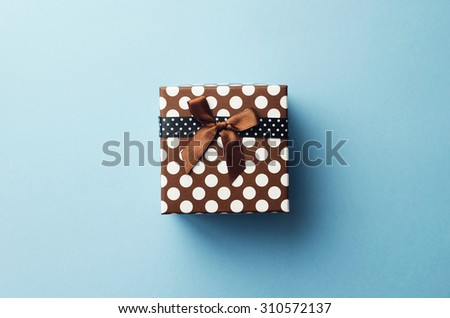 Christmas present box over blue background, above view.