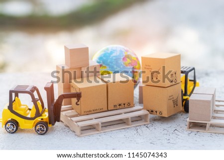 Mini forklift truck load stack of cardboard boxes with shopping cart symbol on wooden pallet and globe near by. Logistics and transportation management ideas and Industry business commercial concept.