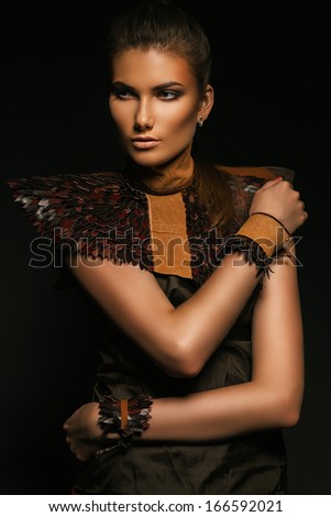pretty girl in brown accessories in dark