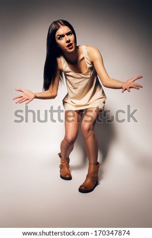 emotional brunette woman in boots