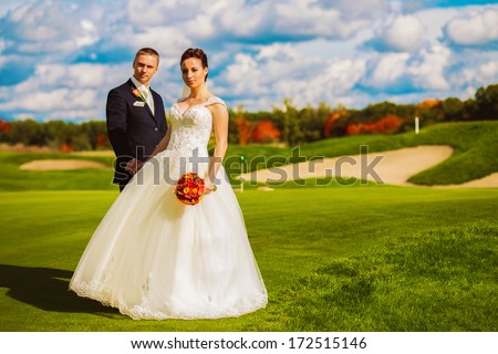 beautiful happy married couple on golf field
