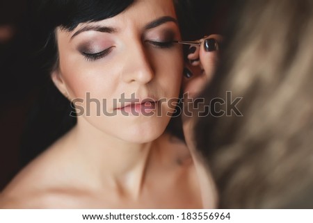 make up artist applying makeup