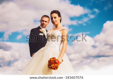 sensual bride and groom on clouds background