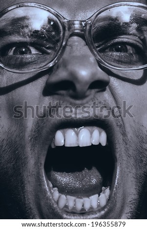 monochrome angry man in old glasses