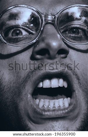 monochrome angry screaming man in glasses
