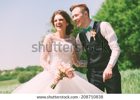 happy laughing married couple on nature