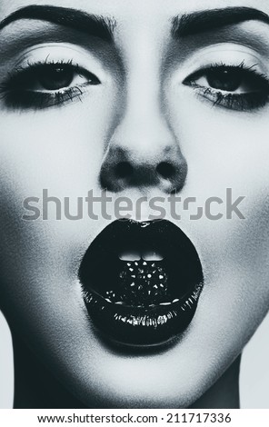 monochrome portrait of woman with bead in mouth