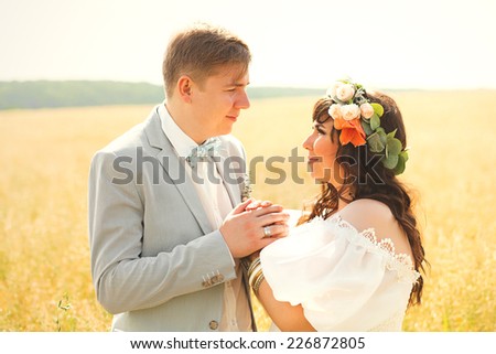 sensual married couple on yellow summer field
