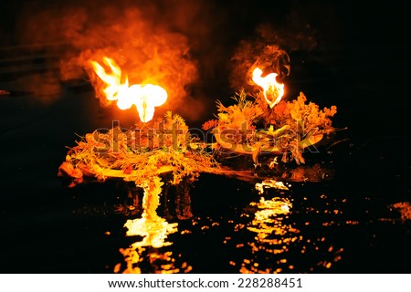 two beautiful wreaths burning on river