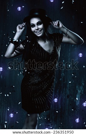 happy woman in black dress with violet lights in dark