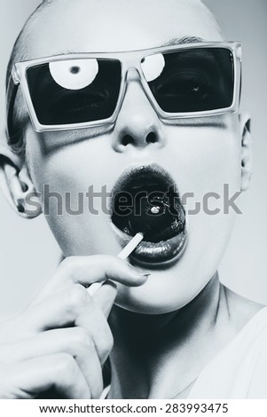 monochrome hot woman in sunglasses with big lollipop in mouth