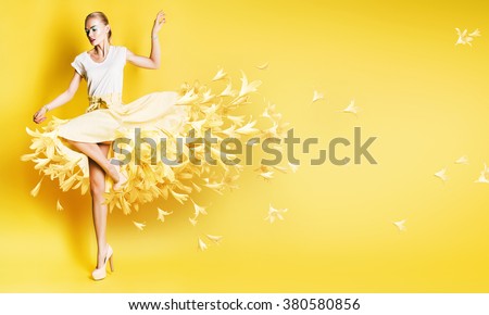 sexy dancing woman in yellow skirt with flowers on yellow background
