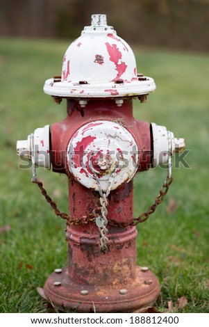 Red and white fire hydrant with peeling paint