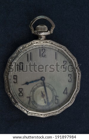 Antique pocket watch on a black background