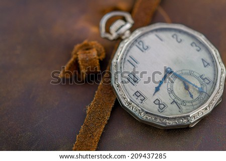 Antique Pocket Watch on Leather Book