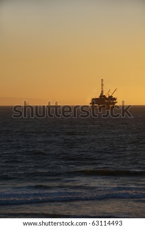Oil Rig at sunset in Huntington Beach. Vertical shot.