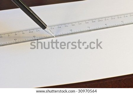 A mechanical pencil writing a design on blank paper
