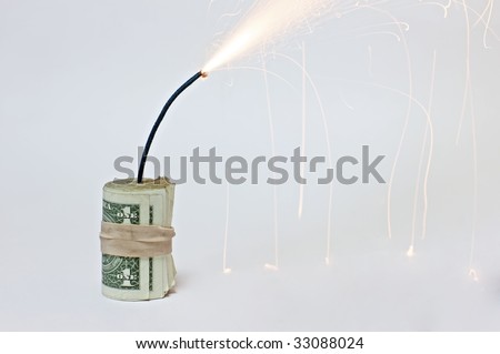A roll of dollar bills attached to a burning fuse on a white background, resembling a bomb made out of dollar bills (http://www.artistovision.com/metaphors/dollar-bomb-white-bg-closeup.html).