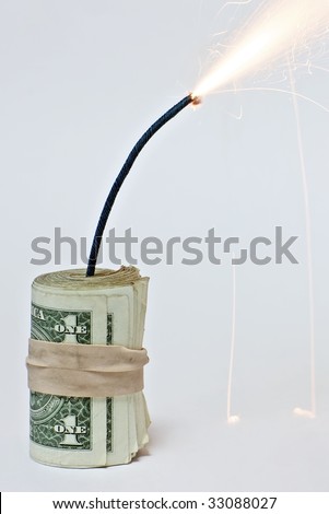Closeup of a roll of dollar bills attached to a burning fuse on a white background, resembling a bomb made of dollar bills (http://www.artistovision.com/metaphors/dollar-bomb-white-bg-closeup.html).