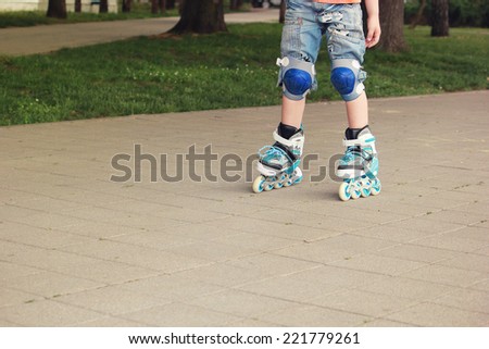 children legs in roller blades