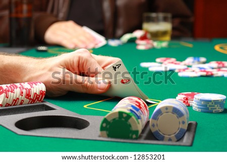 Man checking cards during poker game