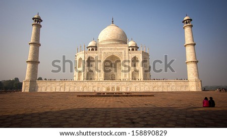 A couple sitting in front of the Taj Mahal in Agra, India.