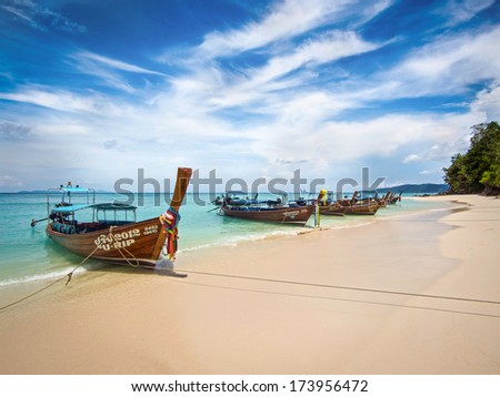 Long-tail boats on the shore of idyllic Bamboo Island, Ko Phi Phi, Thailand.