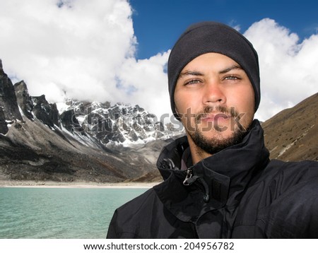 Portrait of male Caucasian hiker in front of beautiful Himalayan landscape on Everest Base Camp trek, Everest Region, Nepal.