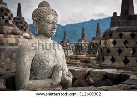 Ancient Buddha statue at Borobudur temple in Yogyakarta, Java, Indonesia.
