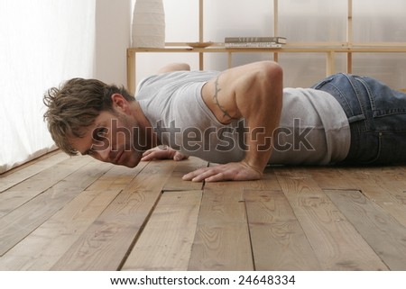 Young man in lounge room doing exercise