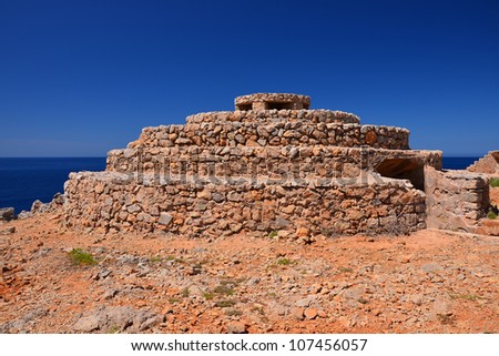 Typical stone megalith near Punta Nati lighthouse, Menorca, Balearic Islands, Spain