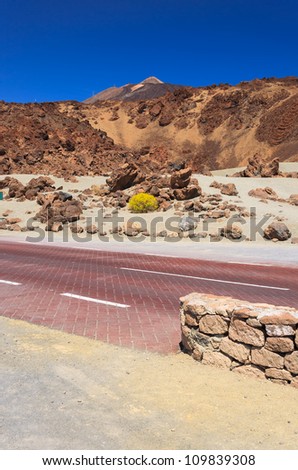 Volcano Pico del Teide with red tarmac road, Teide National Park, Tenerife, Canary Islands, Spain