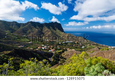 Coastal view village palm tree mountain valley white clouds blue sky, Alojera, La Gomera, Canary Islands