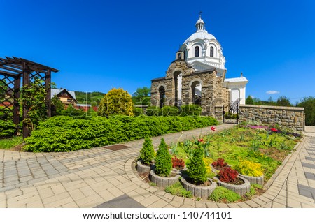 White orthodox church garden flowers, Szlachtowa village, Pieniny Mountains, Poland