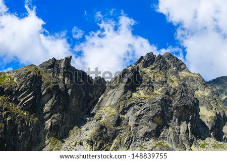 Mountain peaks alpine valley white clouds blue sky, 5 lakes valley (Piat Spisskich Ples), High Tatras, Slovakia