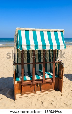 White and green beach chairs on sand with sea view on hot summer day, Ustka, Baltic Sea, Poland