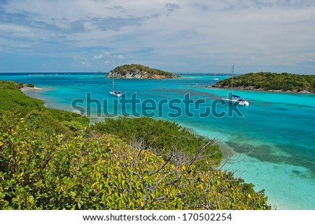 Tropical lagoon near Tobago Cays and yacht anchored on sea, Caribbean Sea