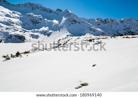Alpine trail from 5 lakes valley to Kozi Wierch peak in winter season, High Tatra Mountains, Poland