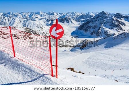 Red sign on ski slope in the mountains of Pitztal winter resort, Austrian Alps