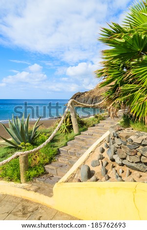 Path and steps to black sand volcanic Prainha beach on east coast of Madeira island, Portugal