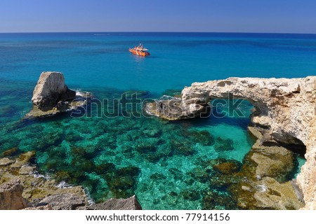 Emerald green sea water with rock arch on Cyprus island