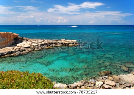 Wonderful turquoise sea water with catamaran sailing on Cyprus island