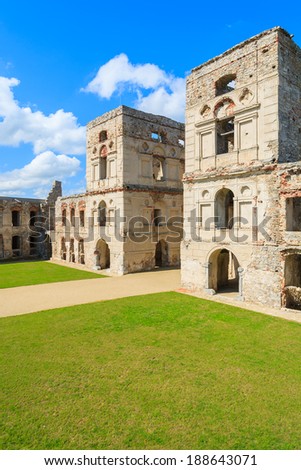 Green lawn courtyard with towers of medieval castle Krzyztopor in spring, Ujazd, Poland