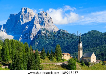 Church on top of hill in village of Pian near Selva di Cadore and beautiful mountains view, South Tirol, Dolomiti Mountains, Italy