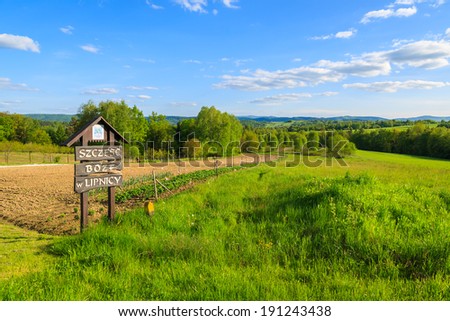 LIPNICA MUROWANA, POLAND - MAY 5, 2014: sign marking entry to village Lipnica Murowana, a rural village important for Catholic people. Sign says God Bless You.