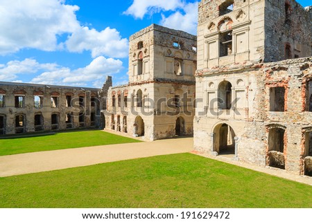 Green lawn courtyard with towers of medieval castle Krzyztopor in spring, Ujazd, Poland