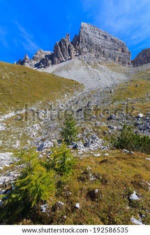Hiking path with view of Tre Cime di Lavaredo famous rock formation, Dolomites Mountains, Italy