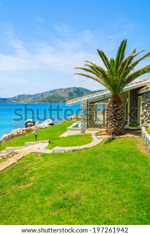 Beautiful holiday villa house on coast of Sardinia island - view from promenade at Spiaggia del Riso beach, Italy